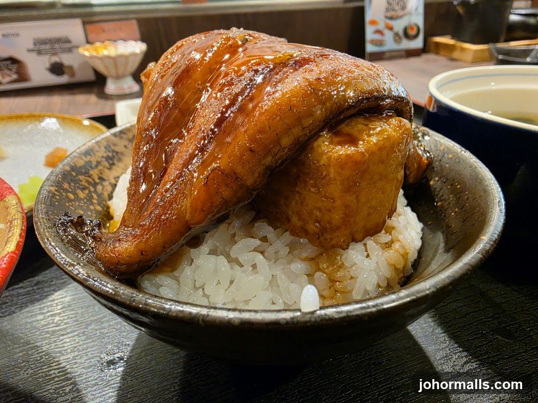 Bowl of grilled fish over rice