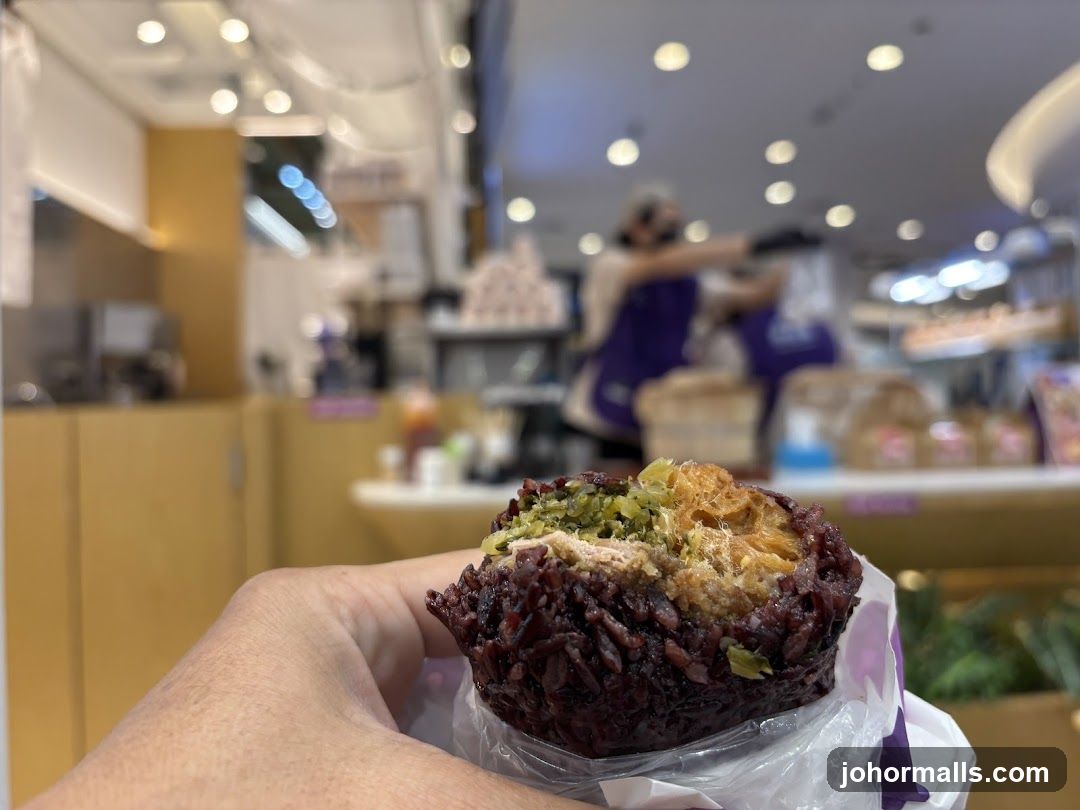 Hand holding food item in store interior