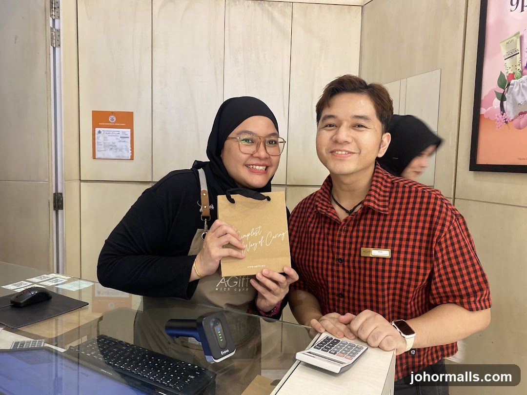 Staff at counter holding branded bag