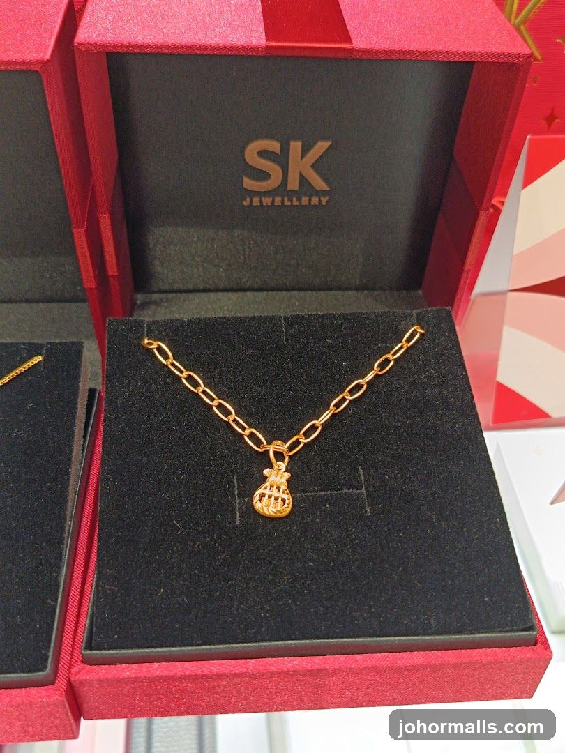 Gold necklace with money bag charm