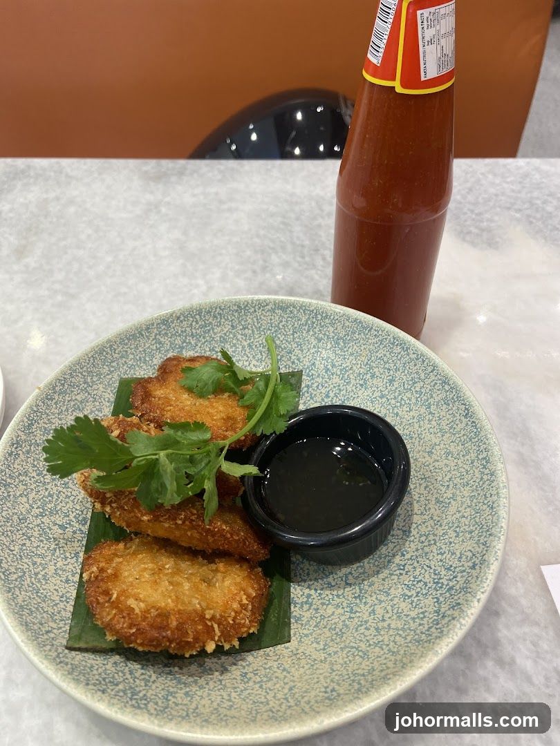 Fried Patties with Dipping Sauce and Hot Sauce Bottle