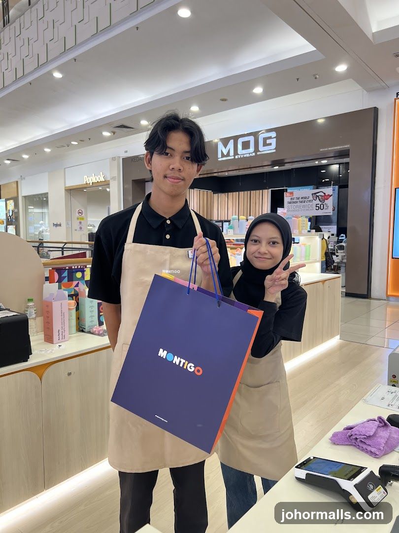 Two employees holding a shopping bag