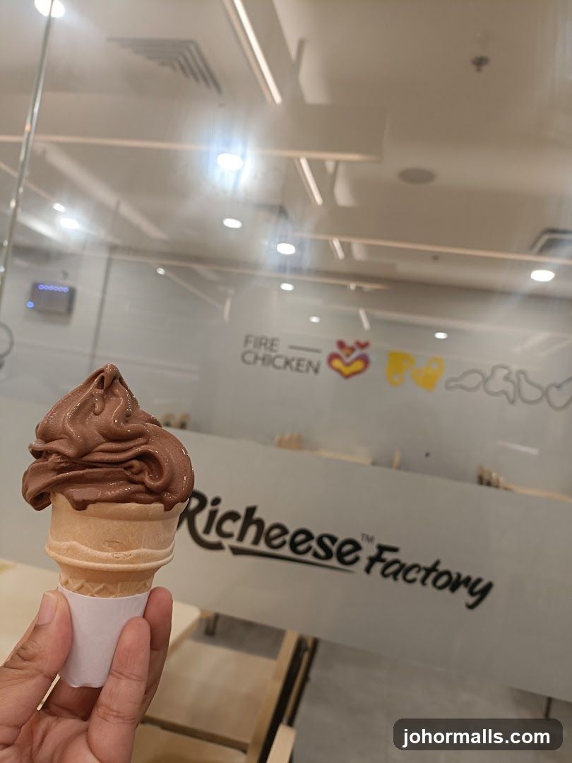 Chocolate ice cream cone in front of a Richeese Factory storefront