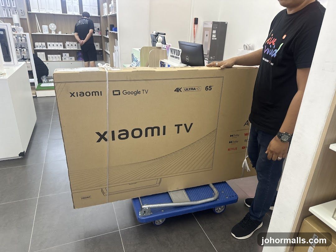 Man with a large Xiaomi TV box
