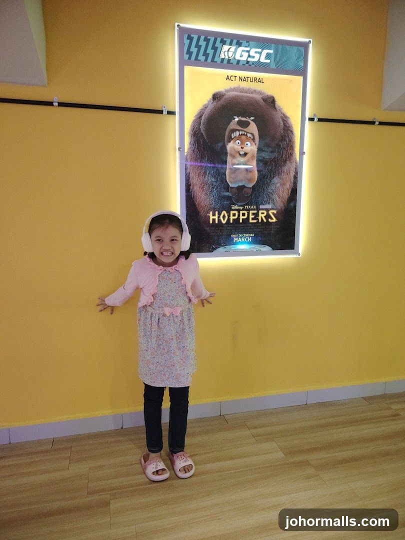 Girl in front of movie poster