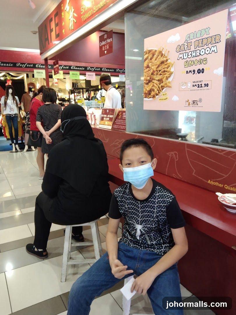 Food stall with promotional poster