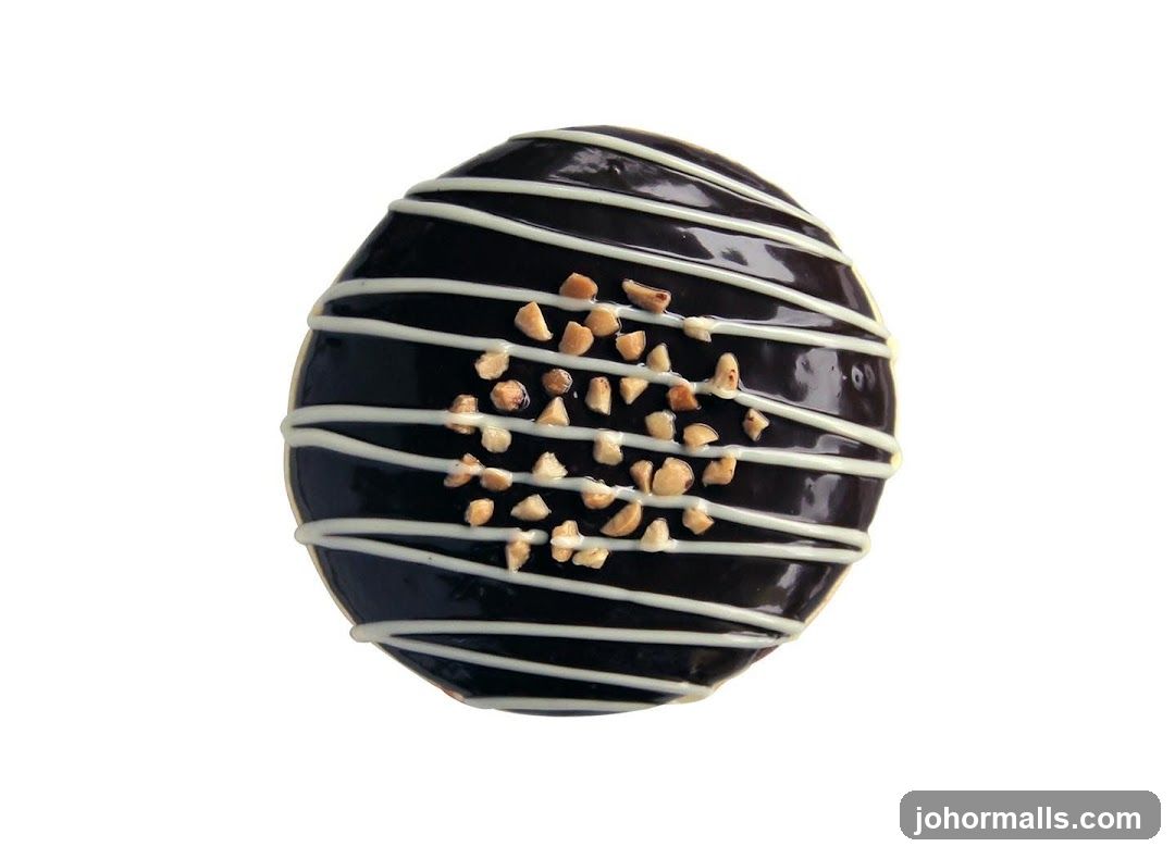 Chocolate Donut with White Drizzle and Nuts