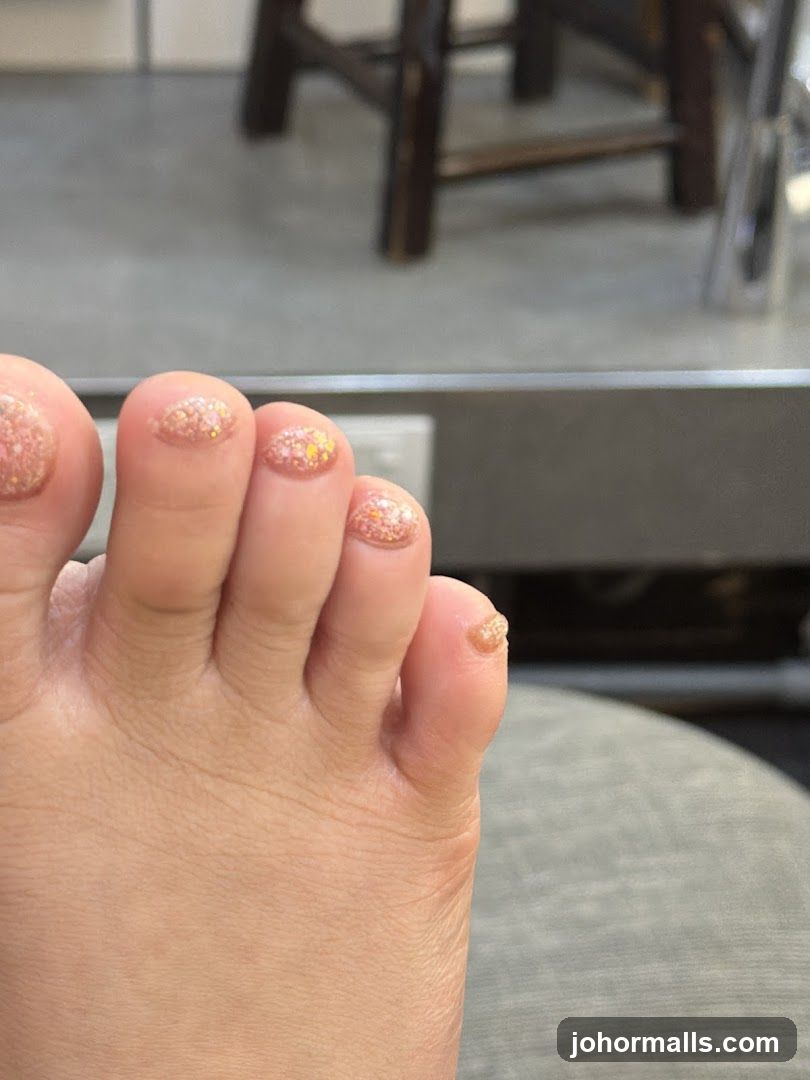 Close-up of a foot with glitter nail polish