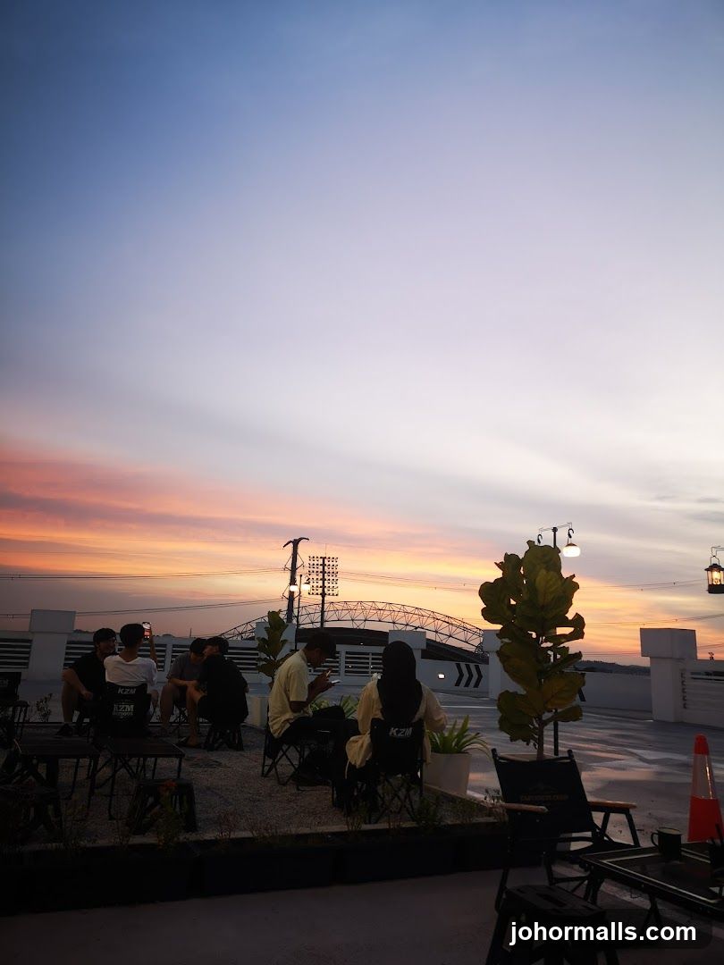 People enjoying sunset at an outdoor seating area
