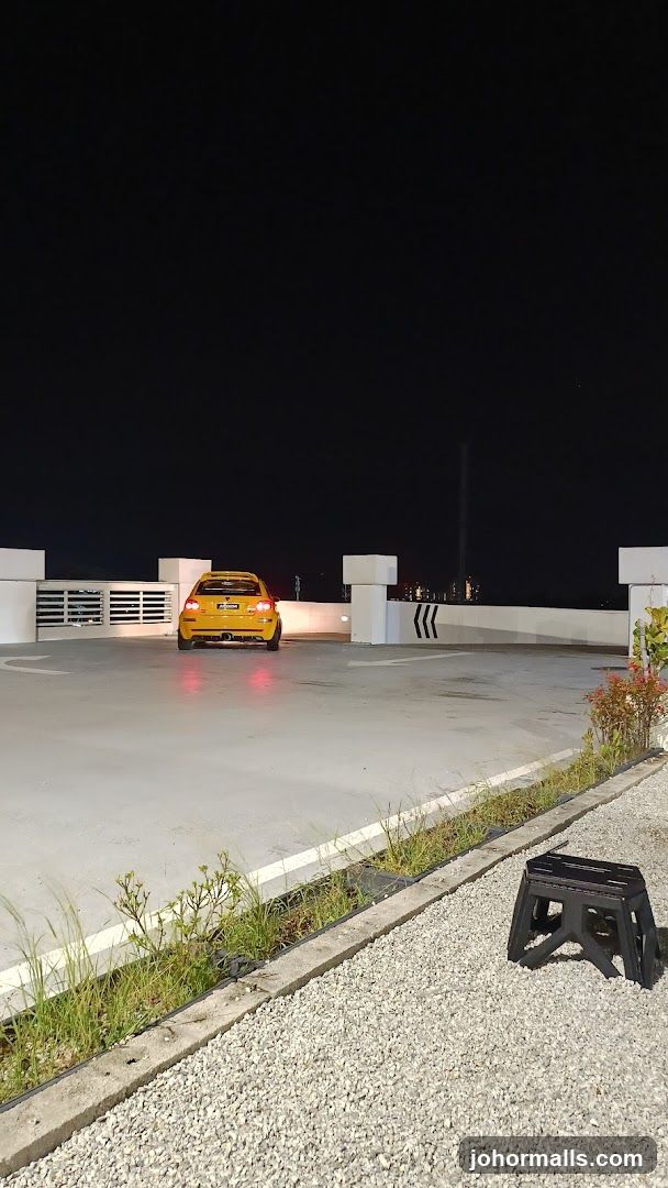 Yellow car parked on rooftop at night