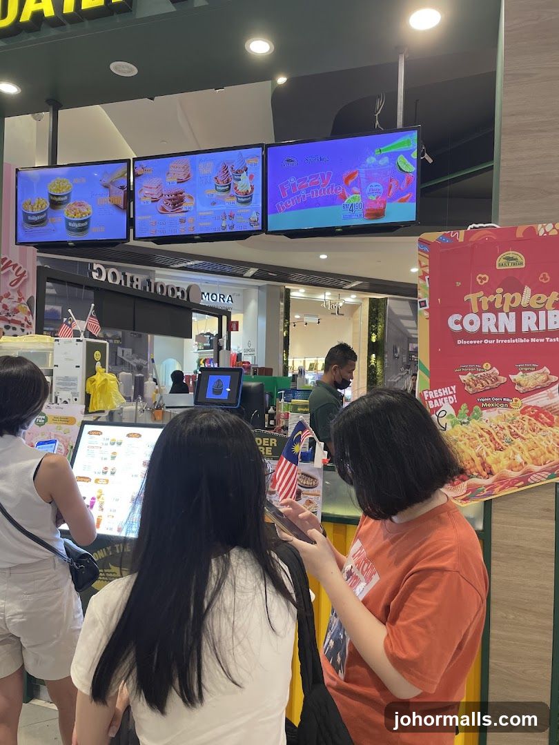 Food court stall with digital menus and promotional displays