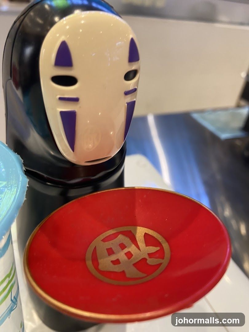 No-Face figurine with red dish