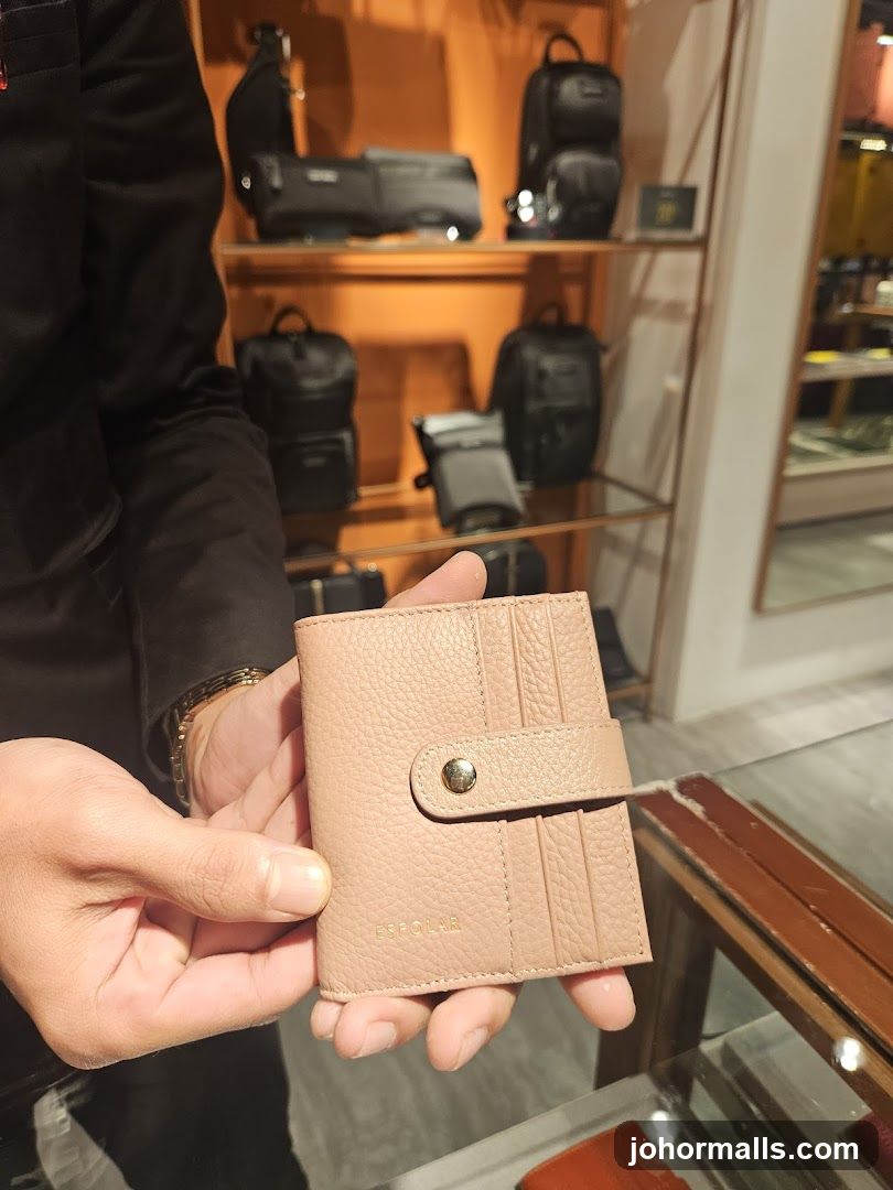 Person holding a pink wallet