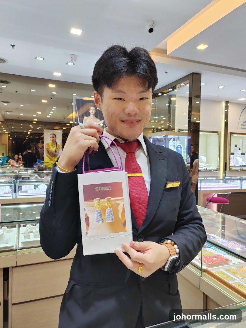 Sales Associate Holding a Branded Bag