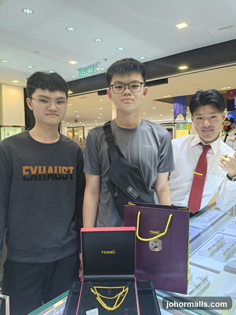 Three people posing with jewelry