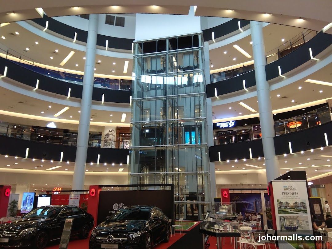 Interior of a multi-level shopping mall with an elevator