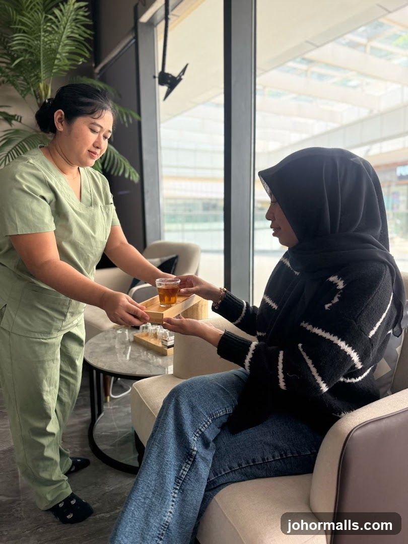 Spa attendant serving tea to a client