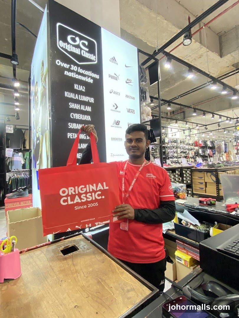 Store Employee Holding Branded Bag