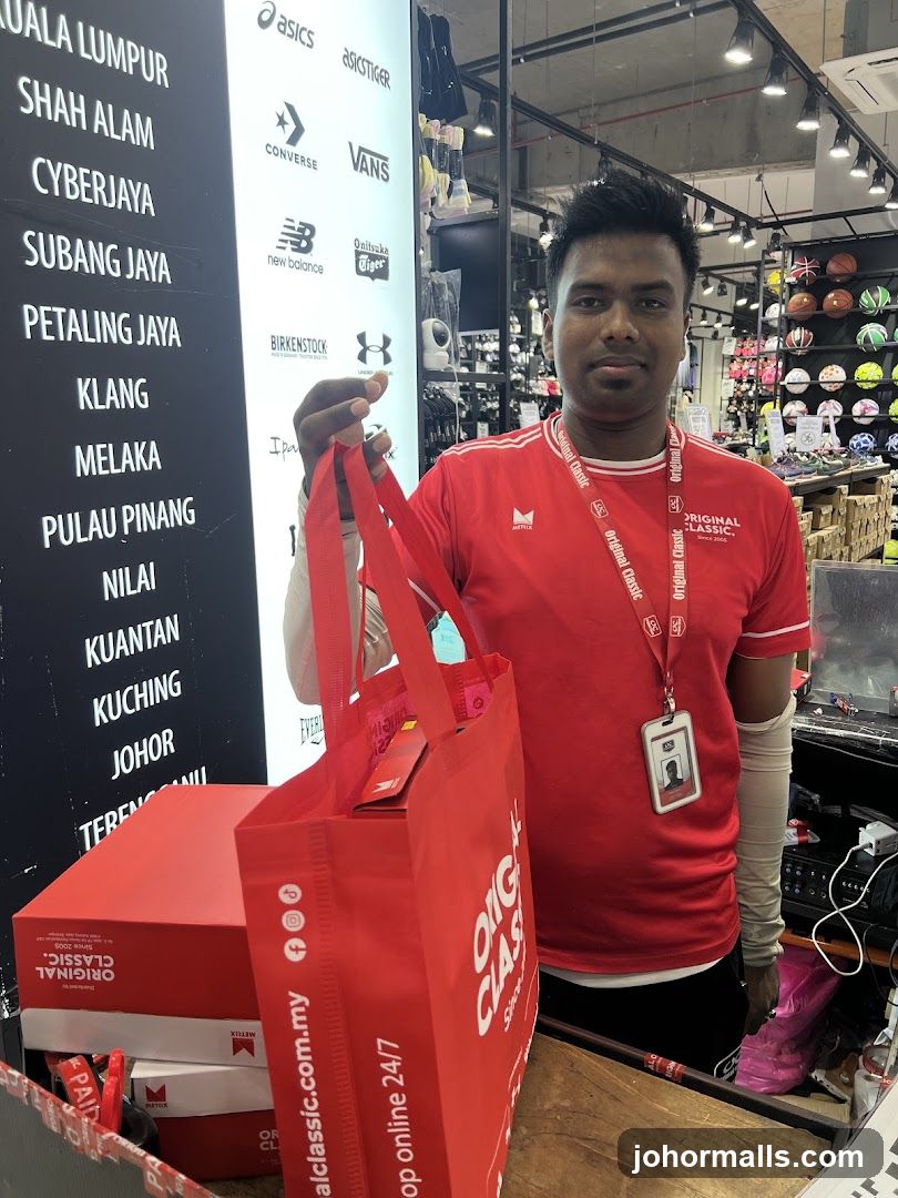 Staff holding a shopping bag and boxes