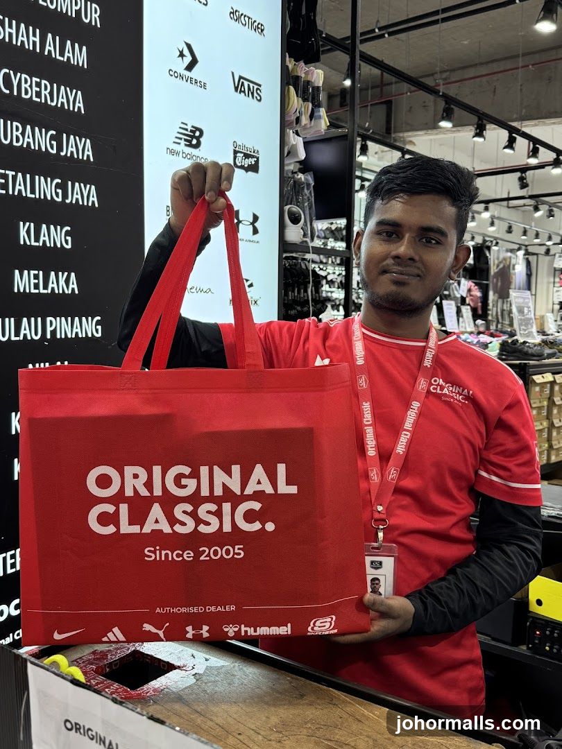 Store Employee Holding Branded Bag