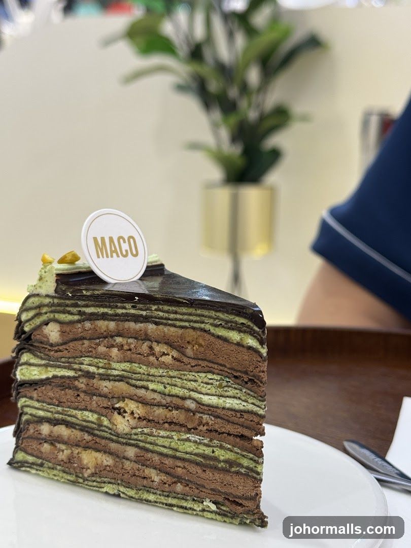 Slice of layered cake with "MACO" topper