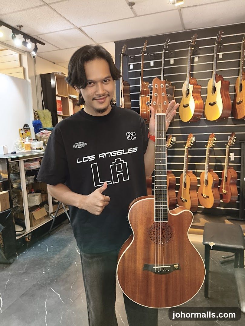 Man holding a guitar in a music store