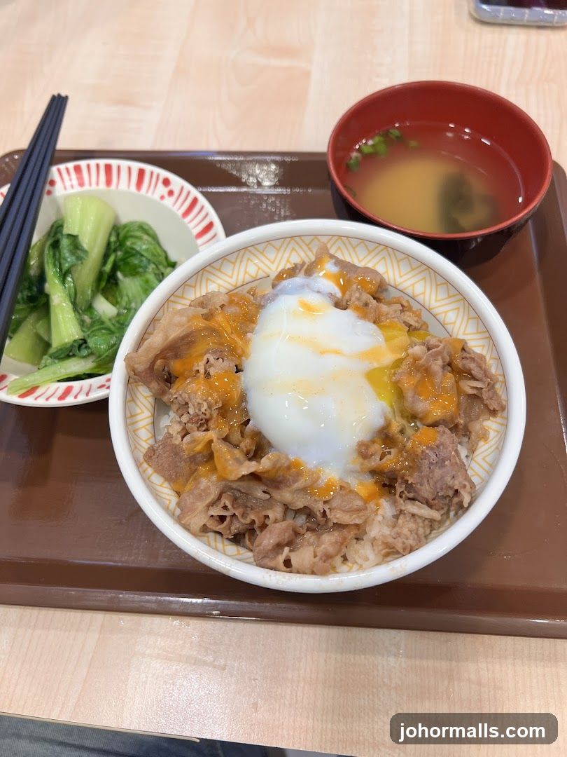 Beef bowl with egg and side of greens