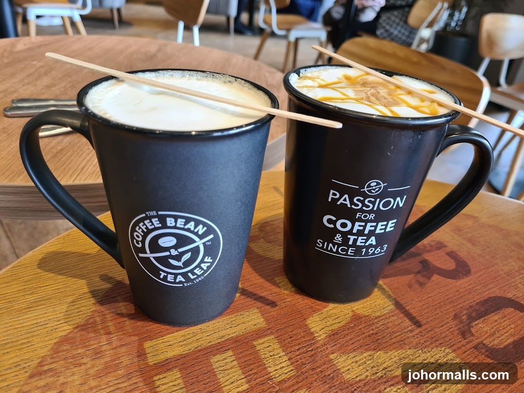 Two coffee mugs with stir sticks