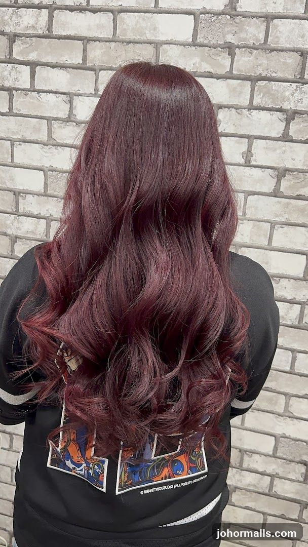 Woman with long, wavy, dark red hair