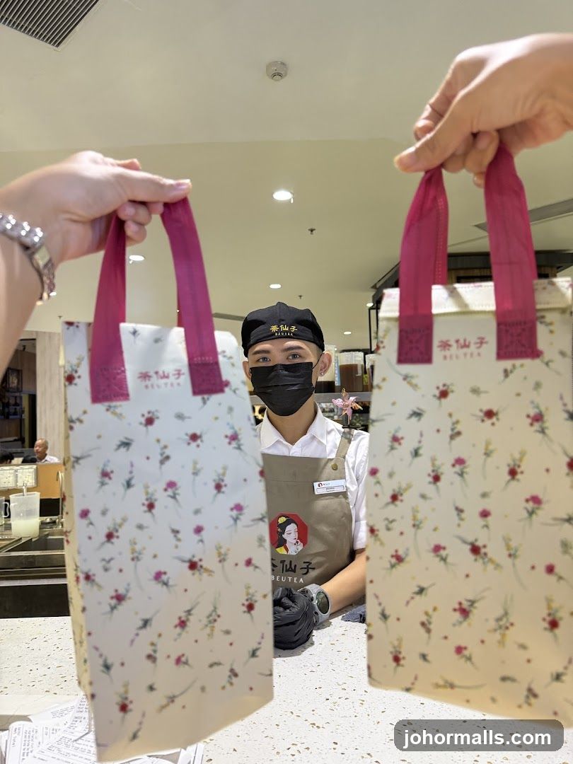 Beverage Shop Staff Holding Branded Bags