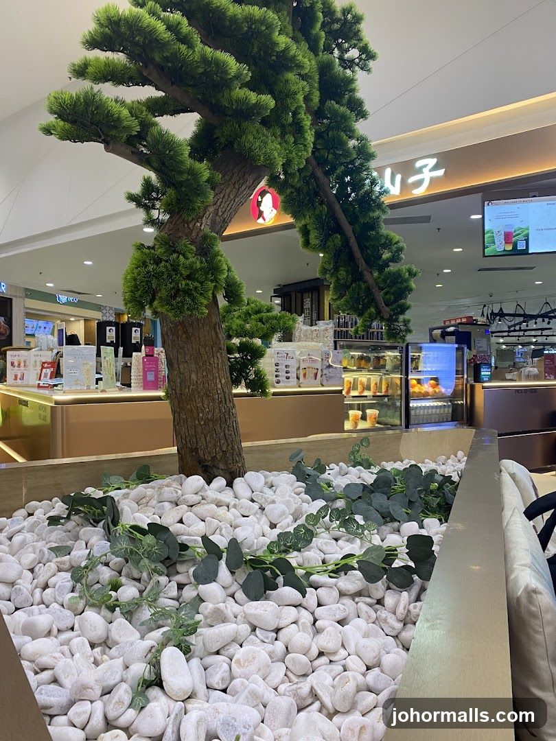 Indoor seating area with decorative tree and cafe counter