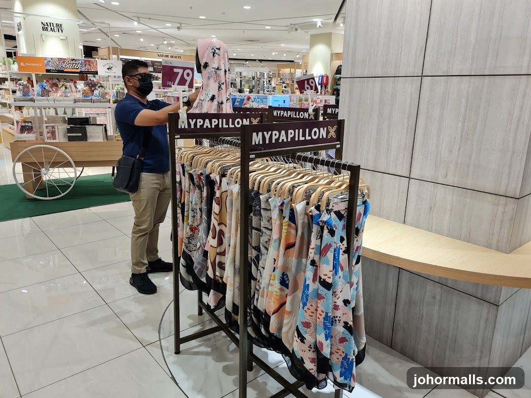 Man browsing scarves in a store