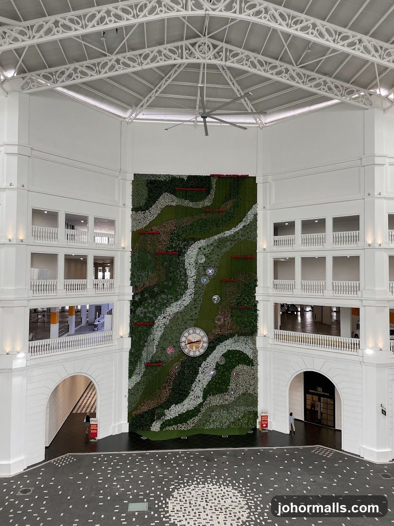Interior of a building with a large vertical garden and clock