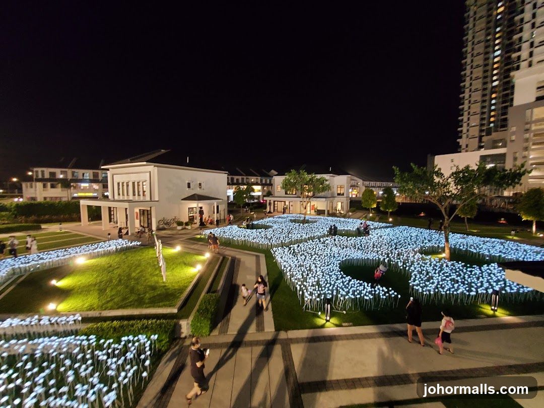 Nighttime illuminated flower garden with buildings