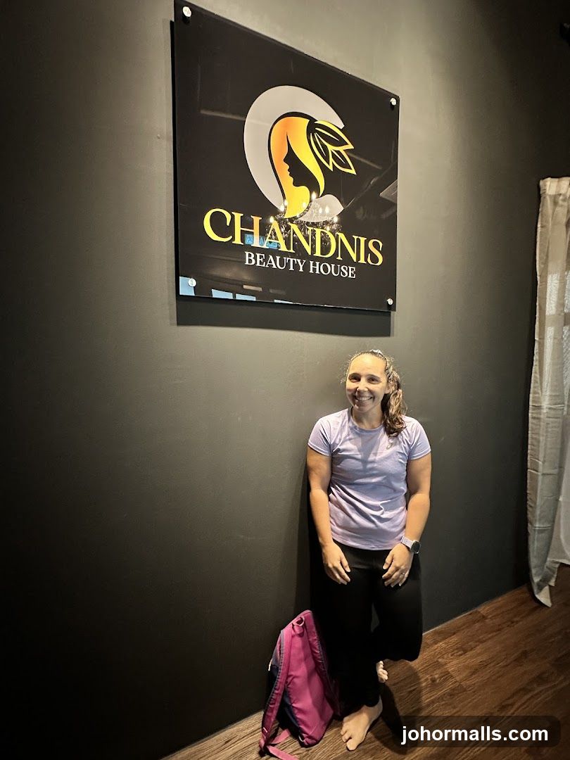 Woman Posing Next to Chandnis Beauty House Sign