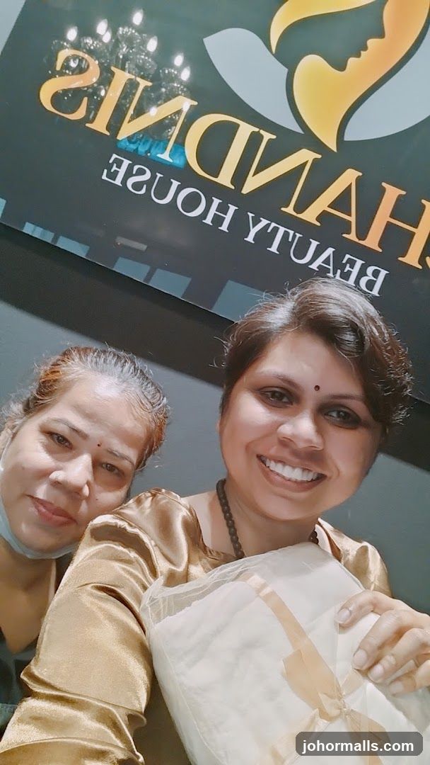 Two Women Posing in Front of a Beauty Salon Sign