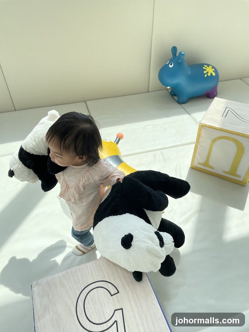 Baby with stuffed pandas