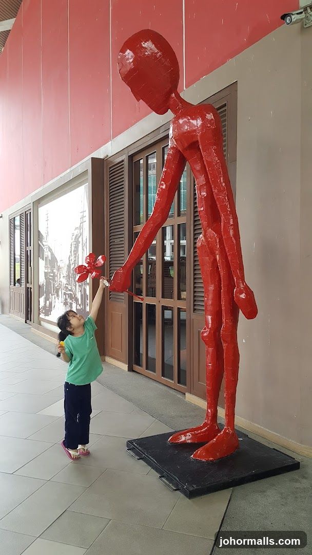 Child Interacting with Sculpture