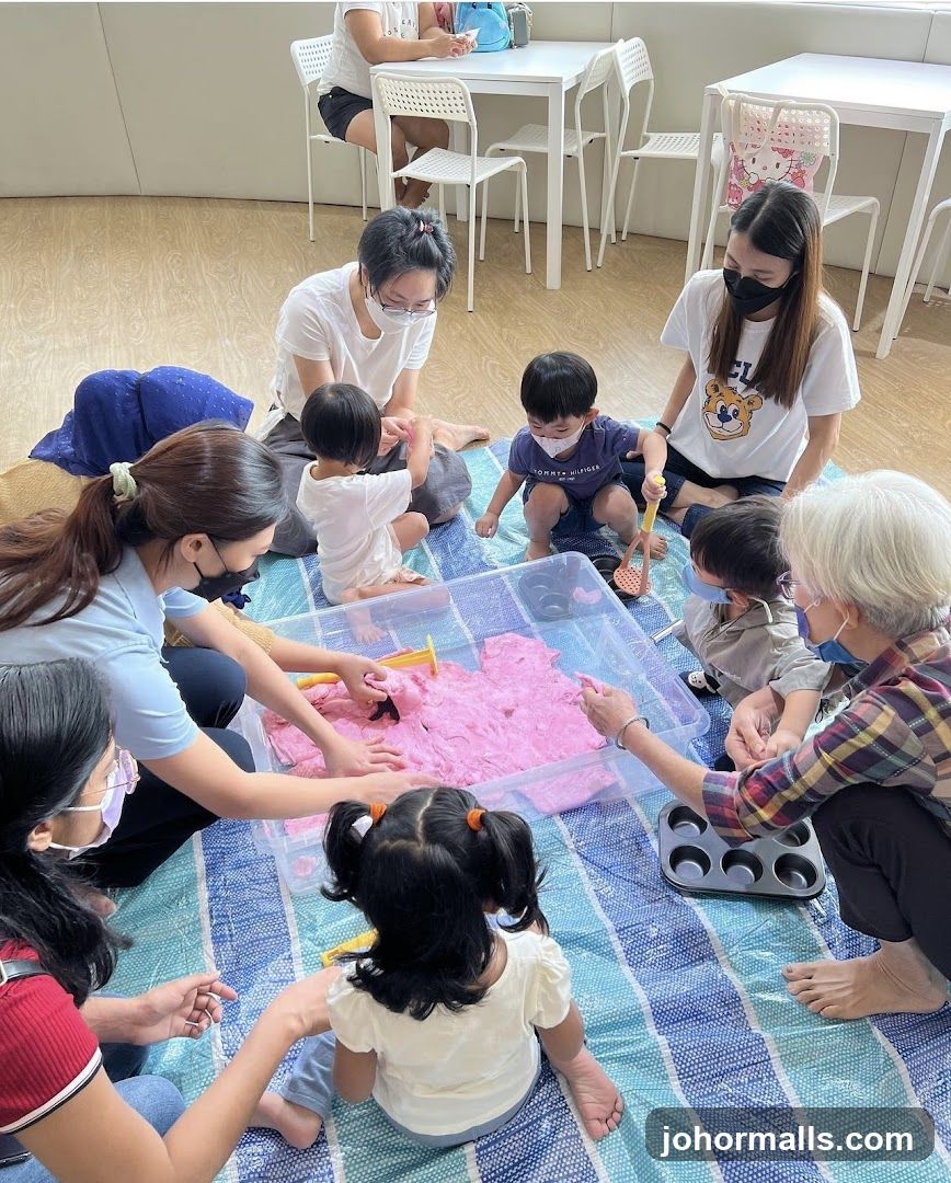 Children and adults playing with pink slime