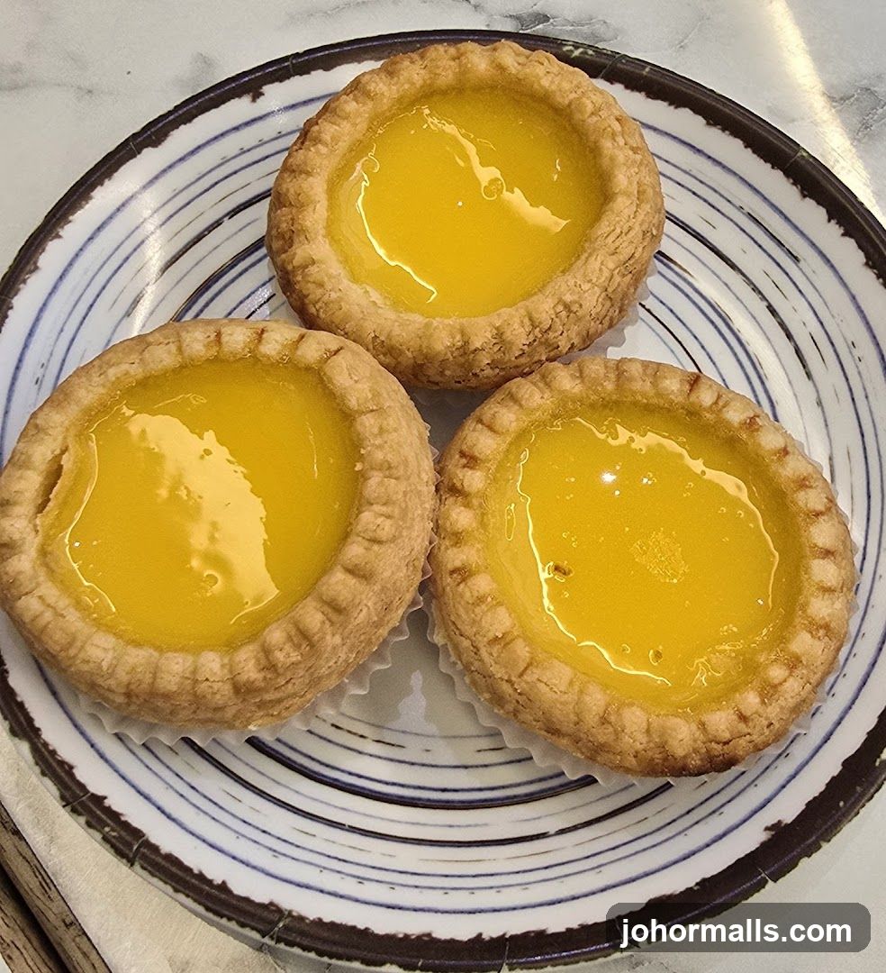 Three Egg Tarts on a Plate