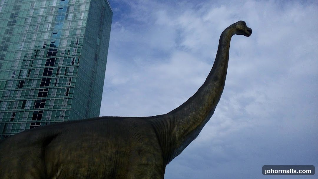 Dinosaur Statue and Modern Building
