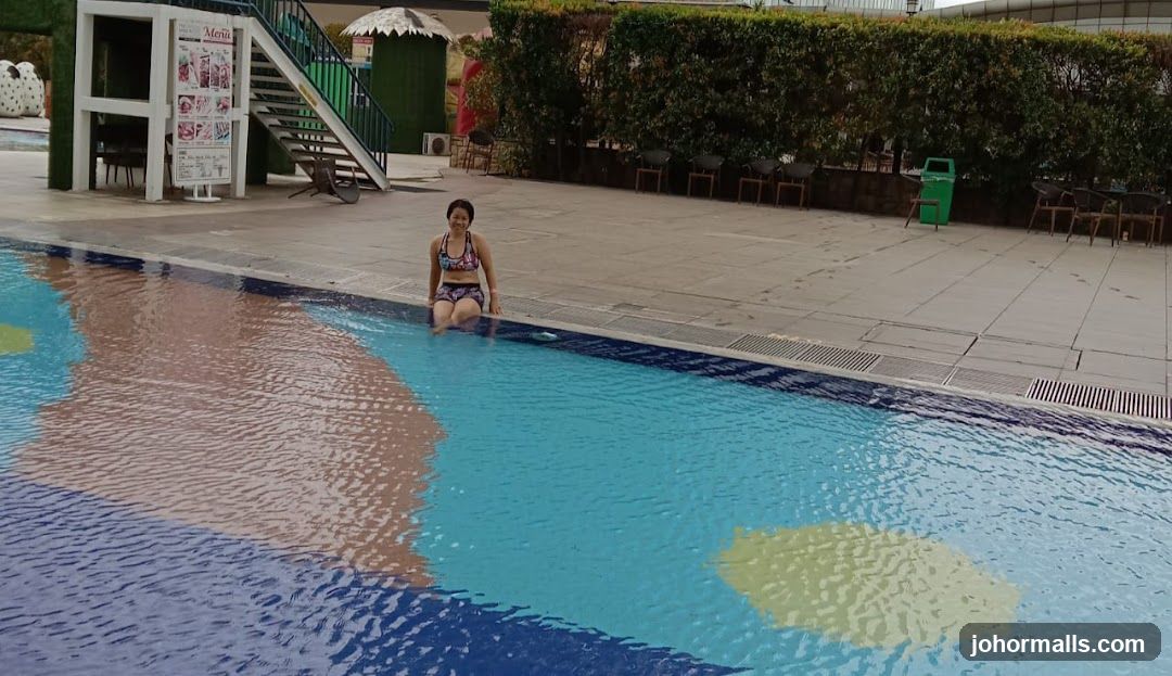 Woman Sitting by the Pool