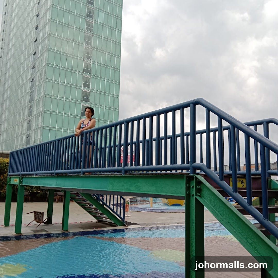 Woman on a bridge over a pool