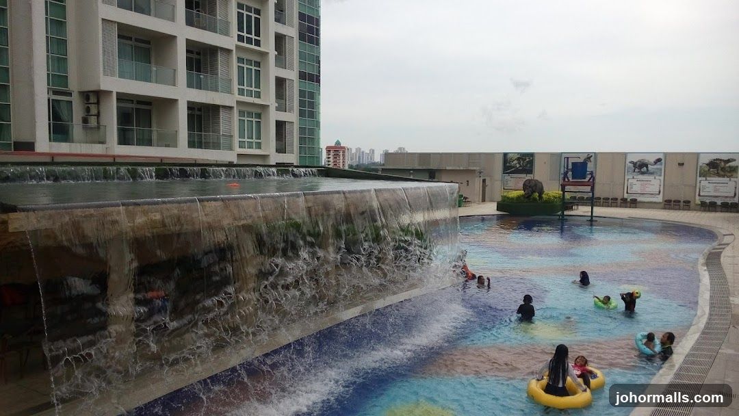 Swimming pool with waterfall and dinosaur displays