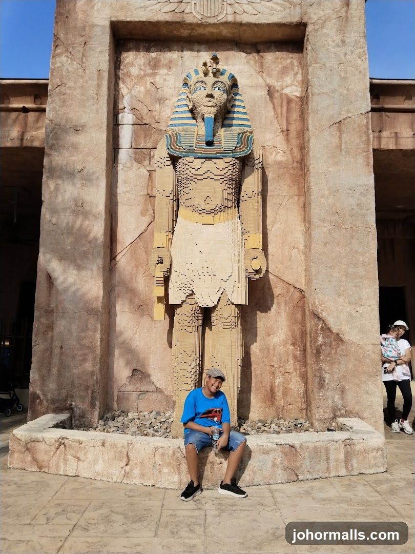Boy Poses in Front of Lego Pharaoh Statue