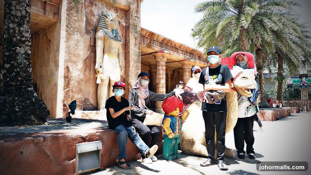 Family Poses in Front of Egyptian-Themed Attraction