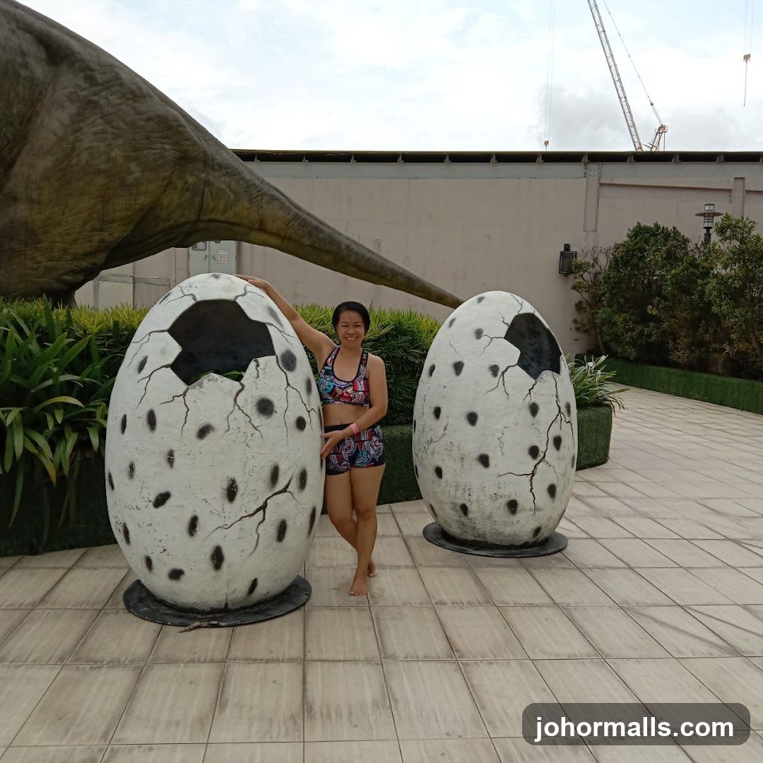 Woman Poses with Dinosaur Eggs and Tail