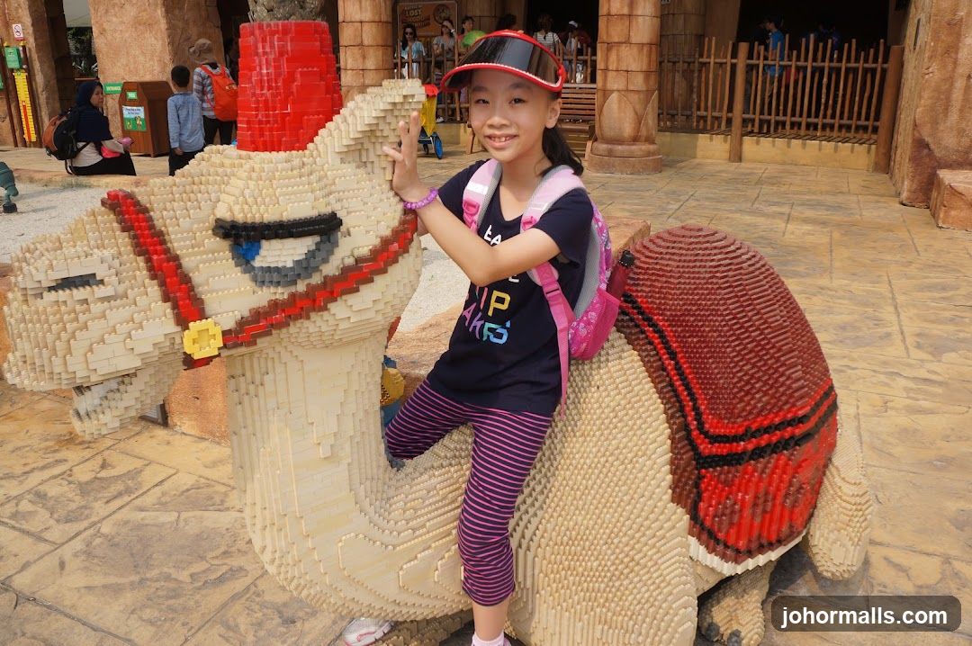 Girl Poses With Lego Camel Sculpture