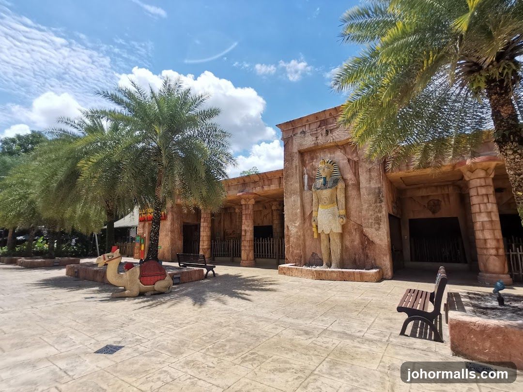 Egyptian-themed attraction with palm trees and a camel statue