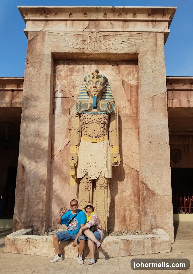 Couple Poses in Front of Lego Pharaoh Statue